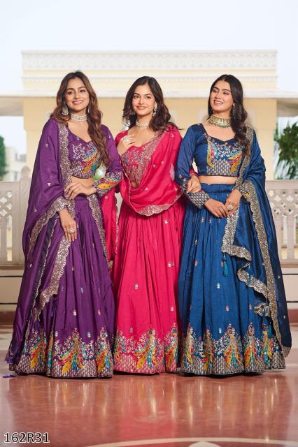Three women in colorful traditional dresses standing together indoors.